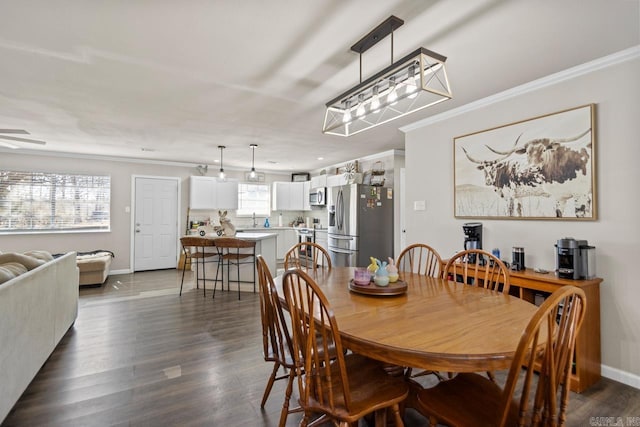 dining area featuring baseboards, dark wood finished floors, and crown molding