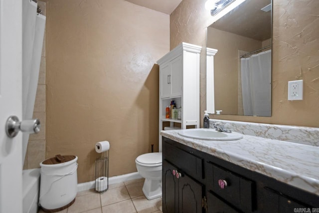 bathroom featuring curtained shower, tile patterned flooring, toilet, vanity, and baseboards