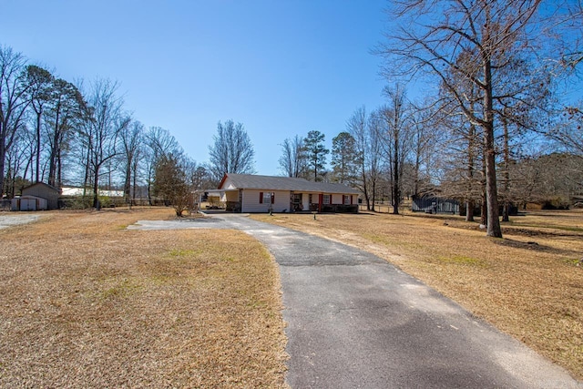 view of front of property with a front yard and driveway