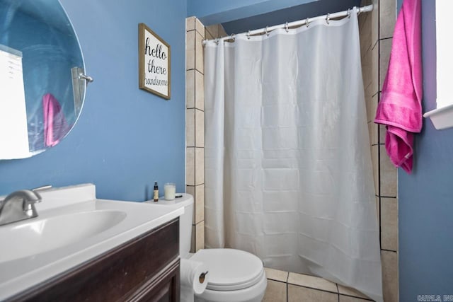 bathroom featuring a shower with shower curtain, vanity, toilet, and tile patterned floors