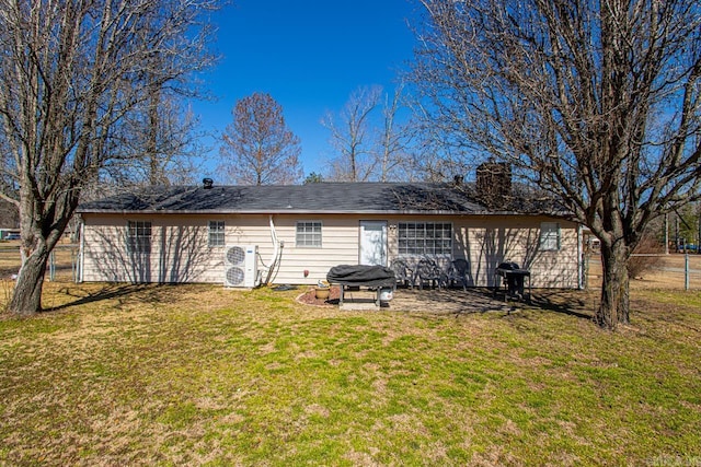 rear view of property with a yard, ac unit, and a patio area