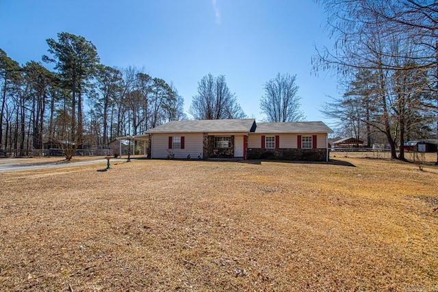 ranch-style home featuring a front yard and fence