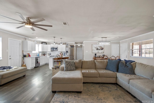 living room with ornamental molding, wine cooler, visible vents, and dark wood finished floors