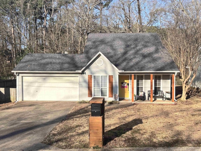 view of front facade with a garage, covered porch, concrete driveway, and roof with shingles