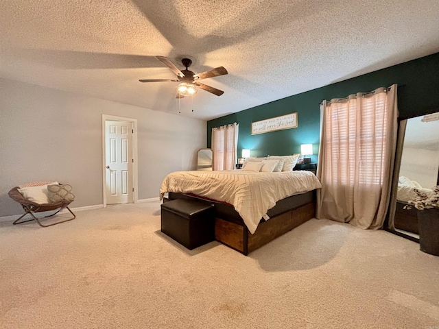 carpeted bedroom featuring a ceiling fan, a textured ceiling, and baseboards