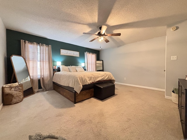 bedroom with a textured ceiling, carpet flooring, a ceiling fan, and baseboards