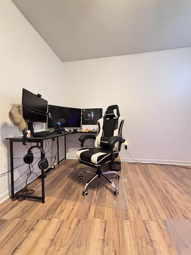 home office with light wood-style flooring and baseboards