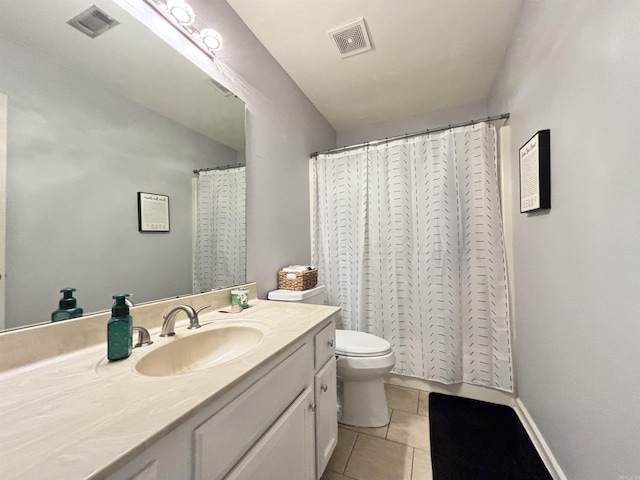 bathroom with toilet, vanity, visible vents, and tile patterned floors