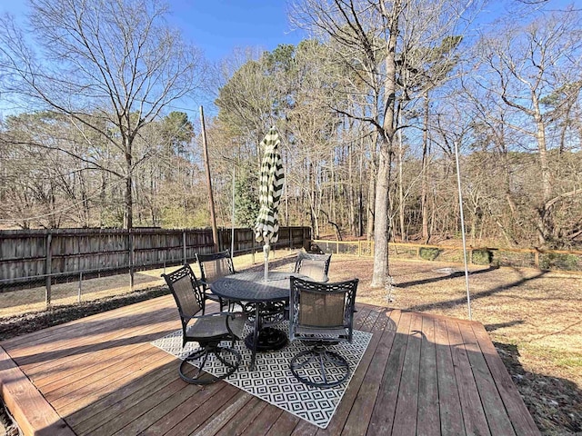 deck featuring outdoor dining space and a fenced backyard