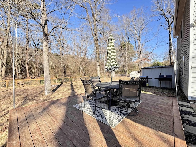 deck with outdoor dining area and area for grilling