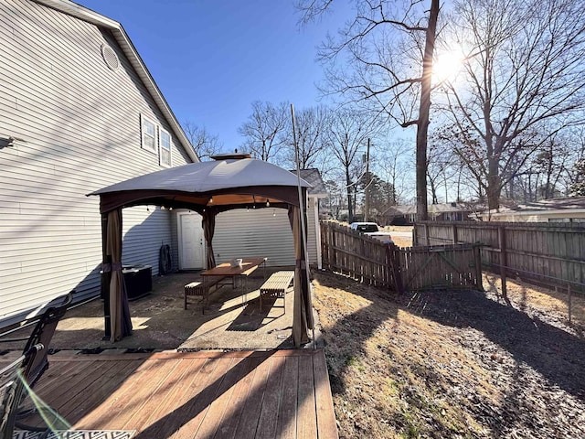 view of yard with a fenced backyard, a deck, and a gazebo