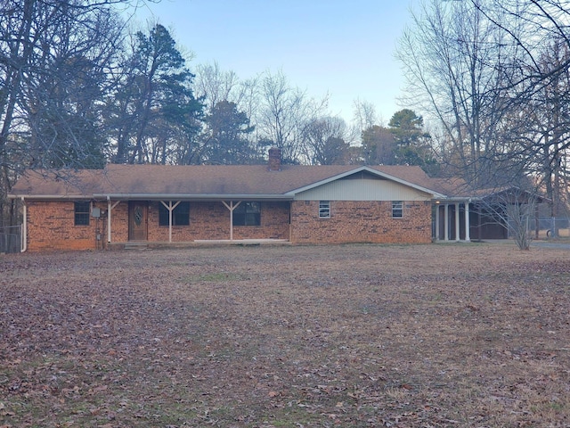 exterior space with a chimney and brick siding