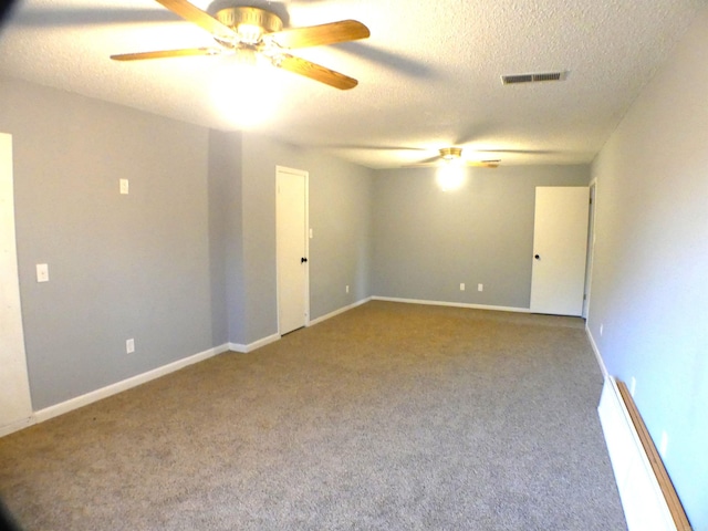 empty room featuring a textured ceiling, carpet floors, ceiling fan, and visible vents