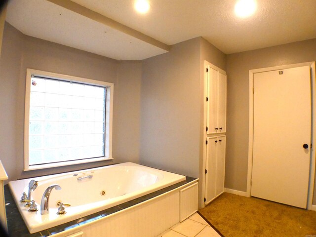 bathroom featuring a whirlpool tub and tile patterned flooring