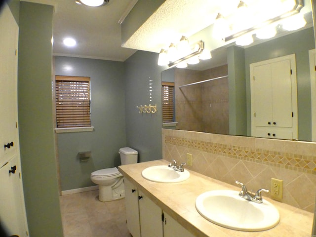 bathroom with tasteful backsplash, crown molding, a sink, and a shower with shower curtain