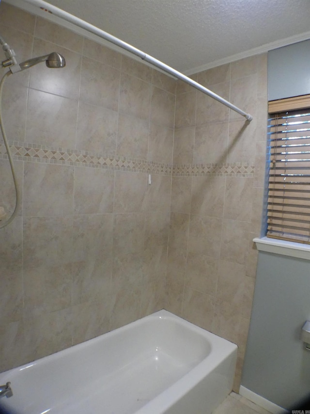 full bathroom with a textured ceiling and bathing tub / shower combination