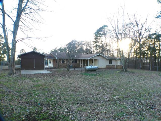 rear view of house with a yard, fence, and a patio