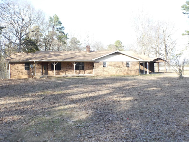 view of front of house featuring brick siding and a chimney