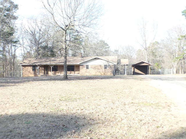 ranch-style home featuring driveway and a chimney