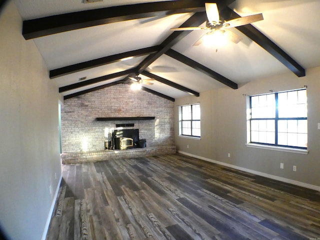 unfurnished living room featuring vaulted ceiling with beams, ceiling fan, baseboards, and wood finished floors