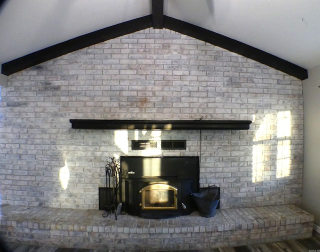 room details featuring a wood stove and beamed ceiling