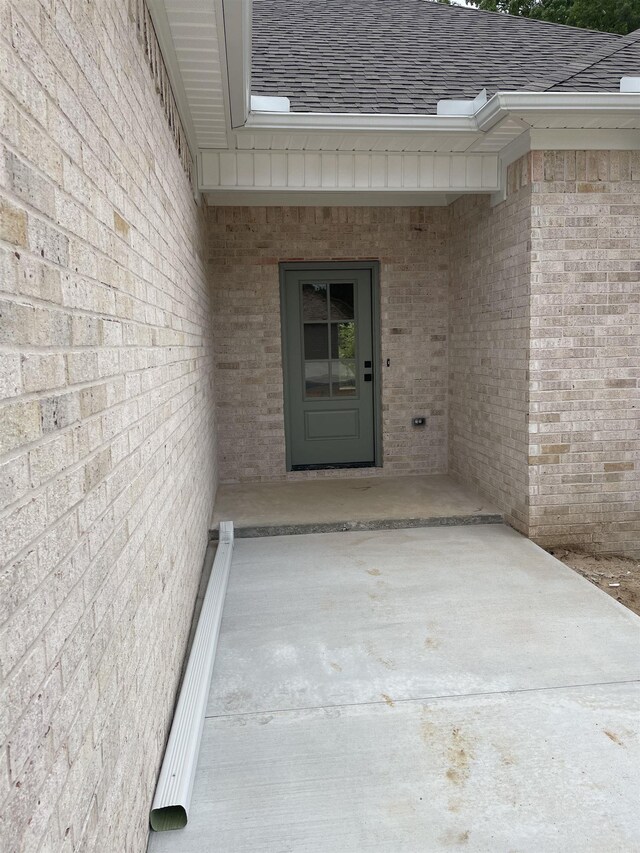 8 Dandelion, Greenbrier, AR 72058 - property entrance with roof with shingles and brick siding