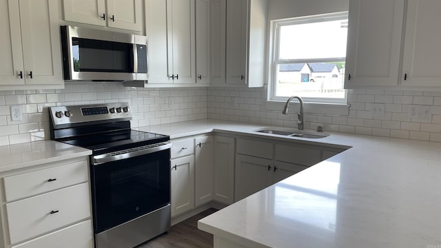 8 Dandelion, Greenbrier, AR 72058 - kitchen featuring stainless steel appliances, a sink, tasteful backsplash, white cabinets, and light stone counters