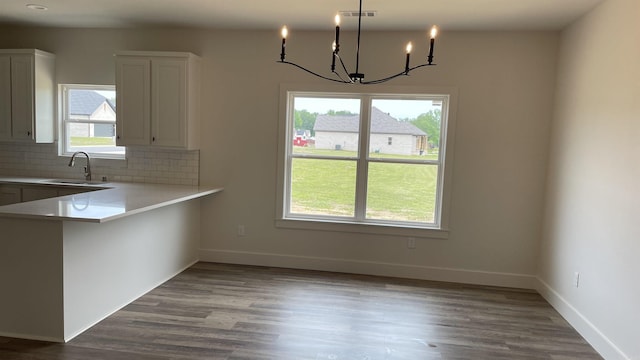 8 Dandelion, Greenbrier, AR 72058 - kitchen featuring a sink, a chandelier, decorative backsplash, light countertops, and dark wood-style floors
