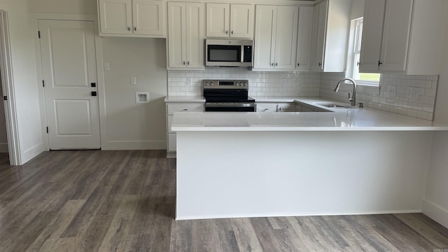 8 Dandelion, Greenbrier, AR 72058 - kitchen featuring stainless steel appliances, a sink, wood finished floors, light countertops, and backsplash