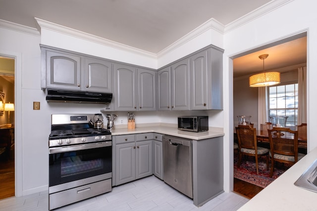 kitchen featuring under cabinet range hood, stainless steel appliances, and light countertops