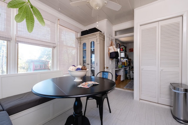 dining area with ceiling fan and crown molding