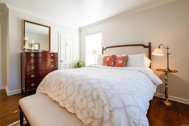 bedroom featuring baseboards, dark wood finished floors, and crown molding