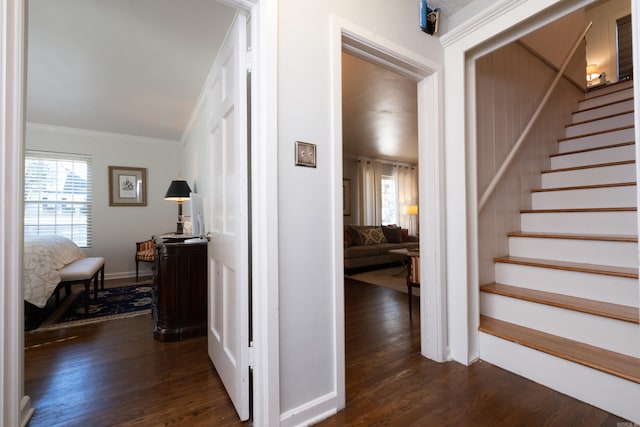 interior space with baseboards, crown molding, stairway, and dark wood-style flooring