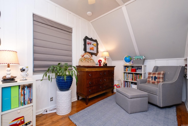 living area with vaulted ceiling and wood finished floors