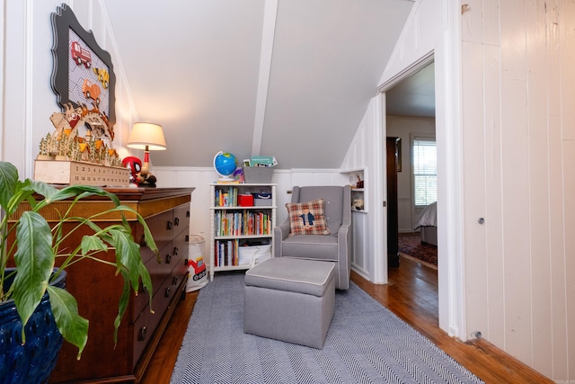 living area with lofted ceiling and wood finished floors