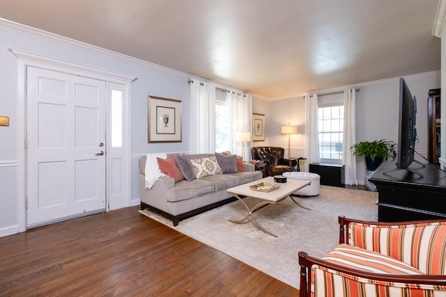 living room featuring ornamental molding, dark wood-style flooring, and plenty of natural light