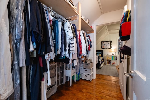 spacious closet with lofted ceiling and wood finished floors