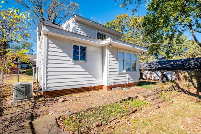 back of property featuring central air condition unit