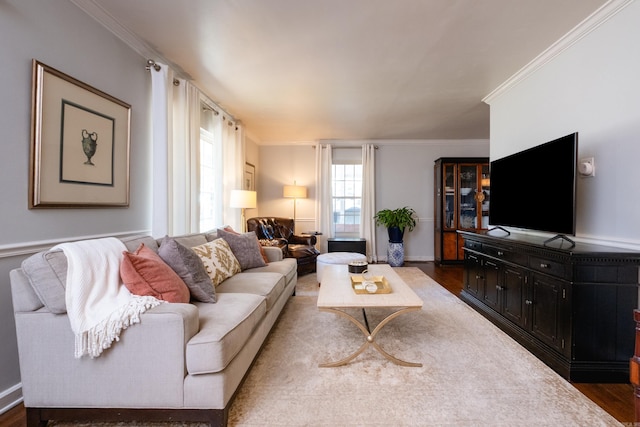 living room featuring baseboards, ornamental molding, and dark wood-type flooring