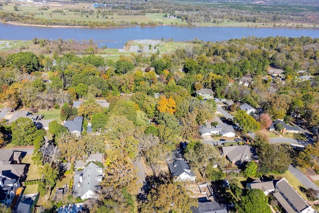 birds eye view of property with a forest view, a water view, and a residential view