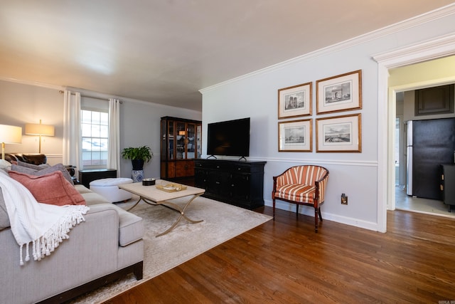 living room featuring ornamental molding, dark wood-style flooring, and baseboards