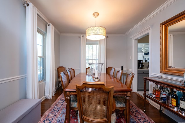 dining area featuring crown molding and dark wood-type flooring