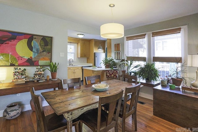 dining space featuring dark wood-style floors and visible vents