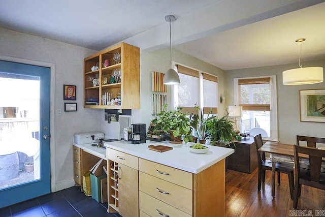 kitchen featuring dark wood-style floors, light countertops, hanging light fixtures, and open shelves