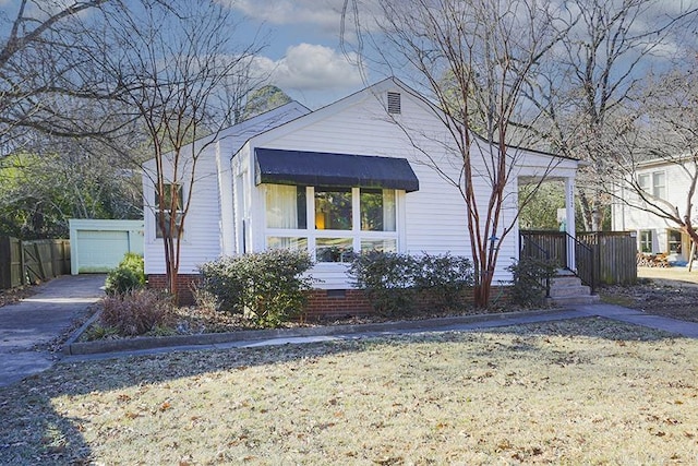 view of front of home featuring a garage, crawl space, and a front lawn