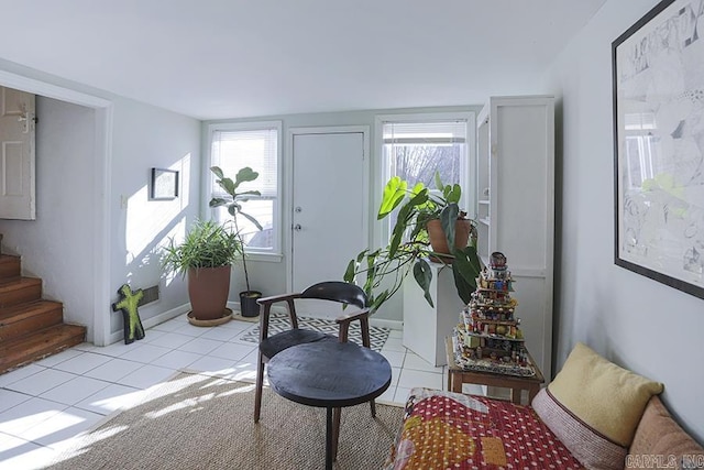 entrance foyer featuring light tile patterned floors, stairway, and plenty of natural light