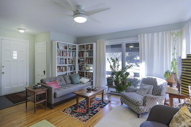 living area featuring ceiling fan and light wood finished floors