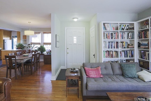 living room with dark wood finished floors and baseboards