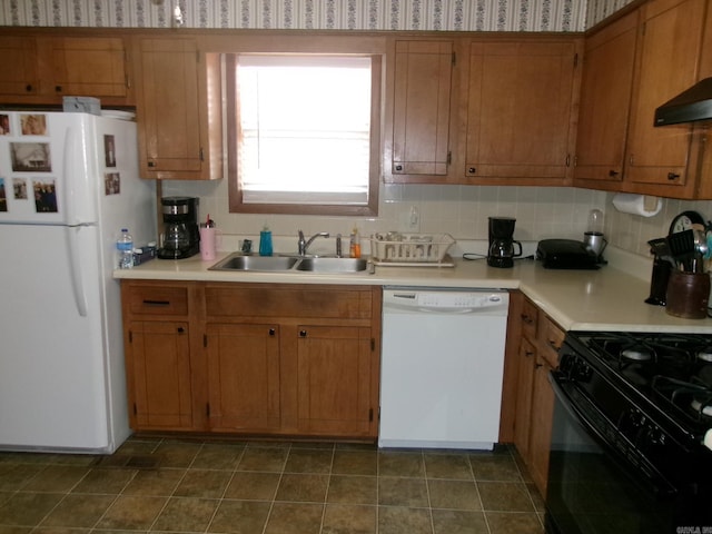 kitchen with white appliances, light countertops, and wallpapered walls