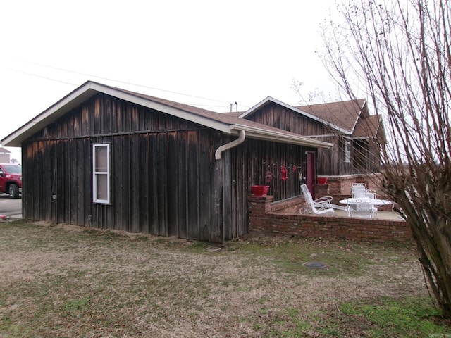 view of home's exterior with a patio area and a lawn